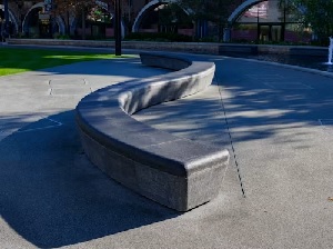 Segmental block seat wall bordering a concrete patio in Virginia 